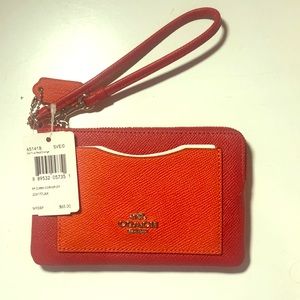 Orange and red leather Coach wristlet